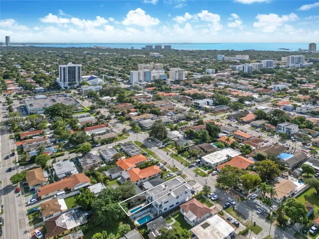 an aerial view of residential houses with city view