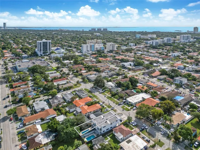 an aerial view of residential houses with city view