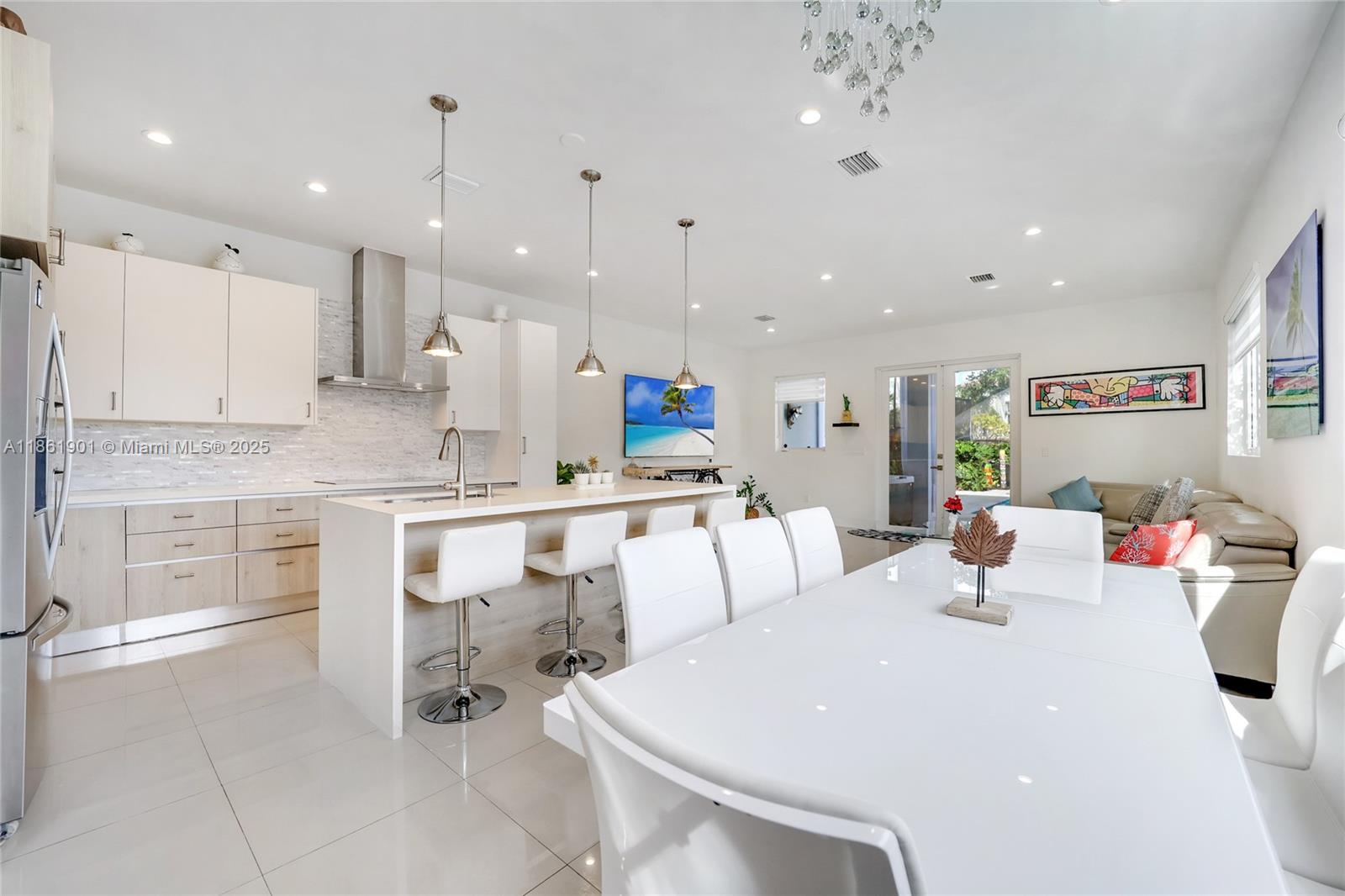 2943 Southwest 23rd Street Miami, FL 33145 - Photo 2 of 21 a large white kitchen with white cabinets and stainless steel appliances