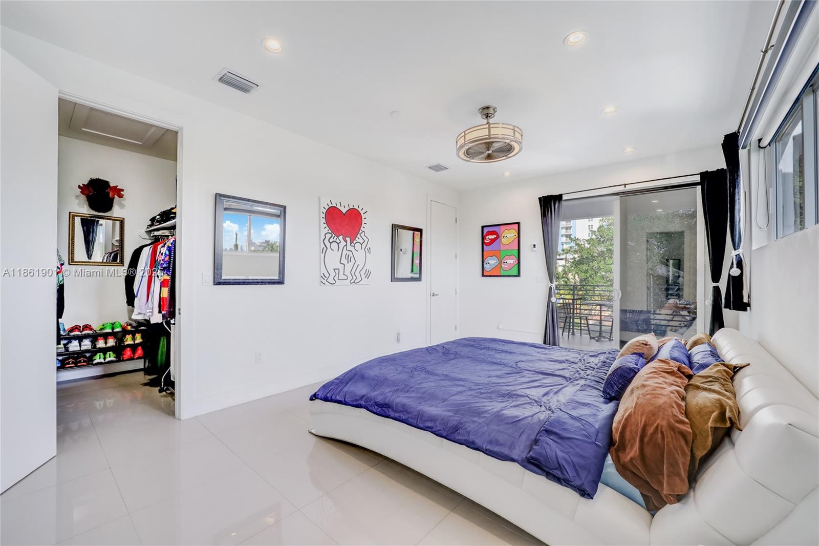 2943 Southwest 23rd Street Miami, FL 33145 - Photo 8 of 21 a bedroom with a bed and a walk in closet