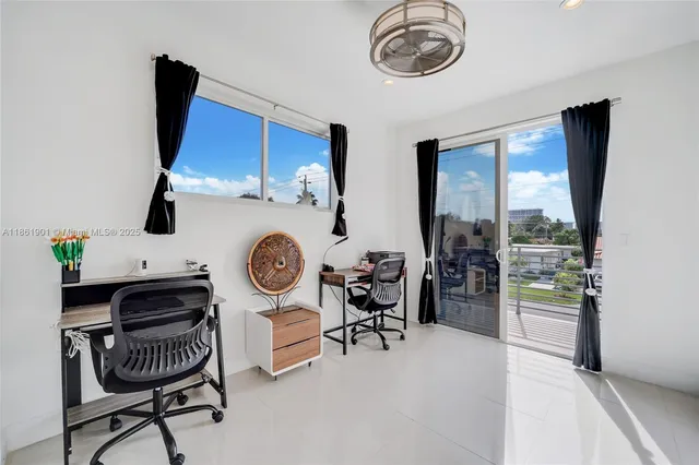 a view of a dining room with furniture a chandelier and wooden floor