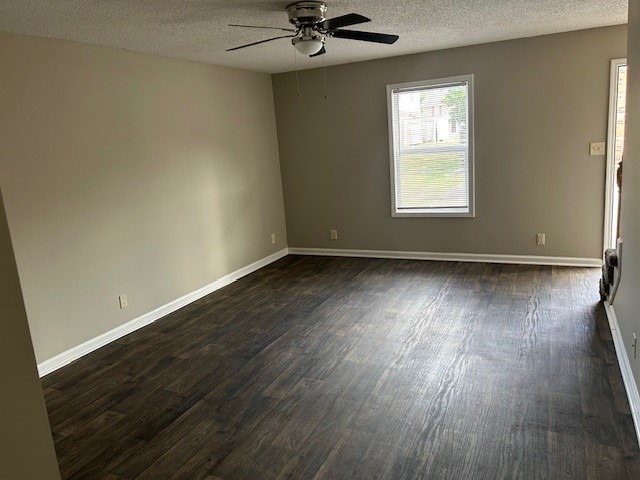 292 Raleigh Drive, Unit 3D Clarksville, TN 37043 - Photo 4 of 7 an empty room with wooden floor chandelier fan and windows