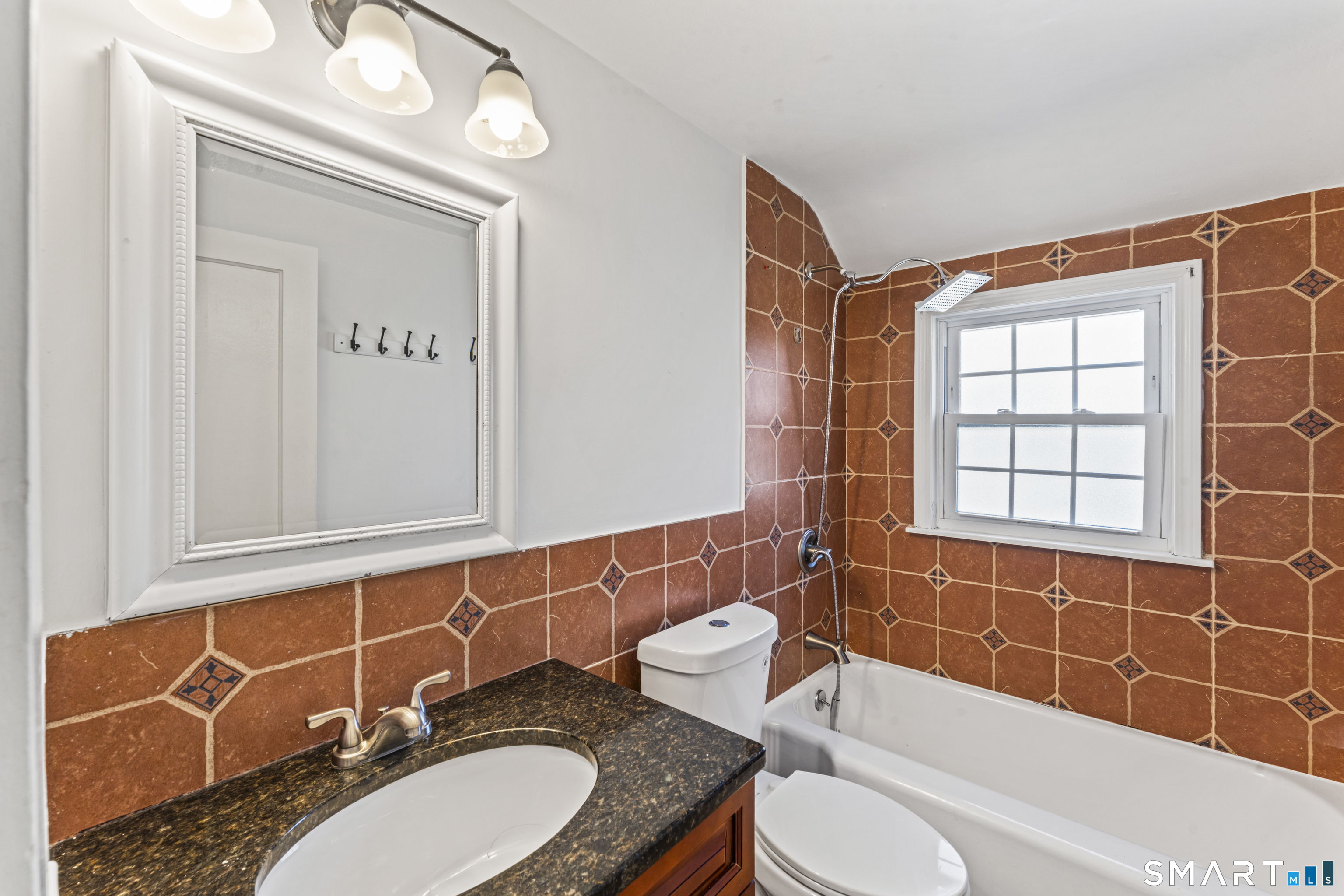 167 Hollow Tree Ridge Road Darien, CT 06820 - Photo 12 of 38 a bathroom with a granite countertop sink mirror toilet and bathtub