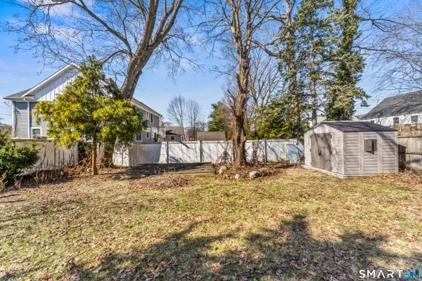 a view of a yard covered with snow in front of house