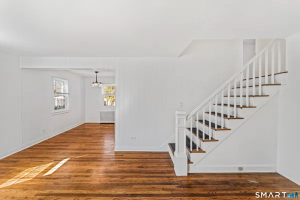 a view of entryway and hall with wooden floor