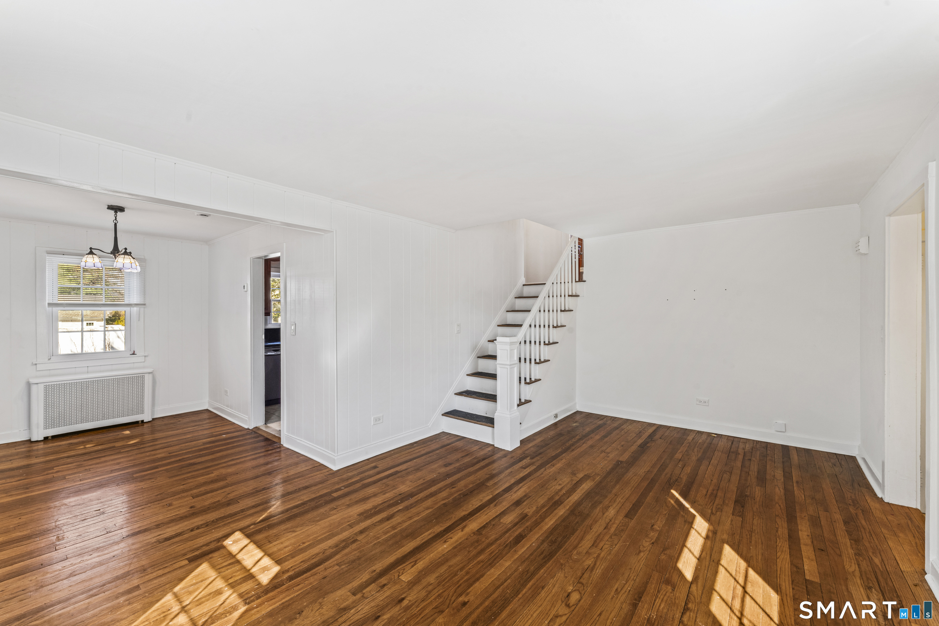 167 Hollow Tree Ridge Road Darien, CT 06820 - Photo 17 of 38 a bedroom with a bed and wooden floor