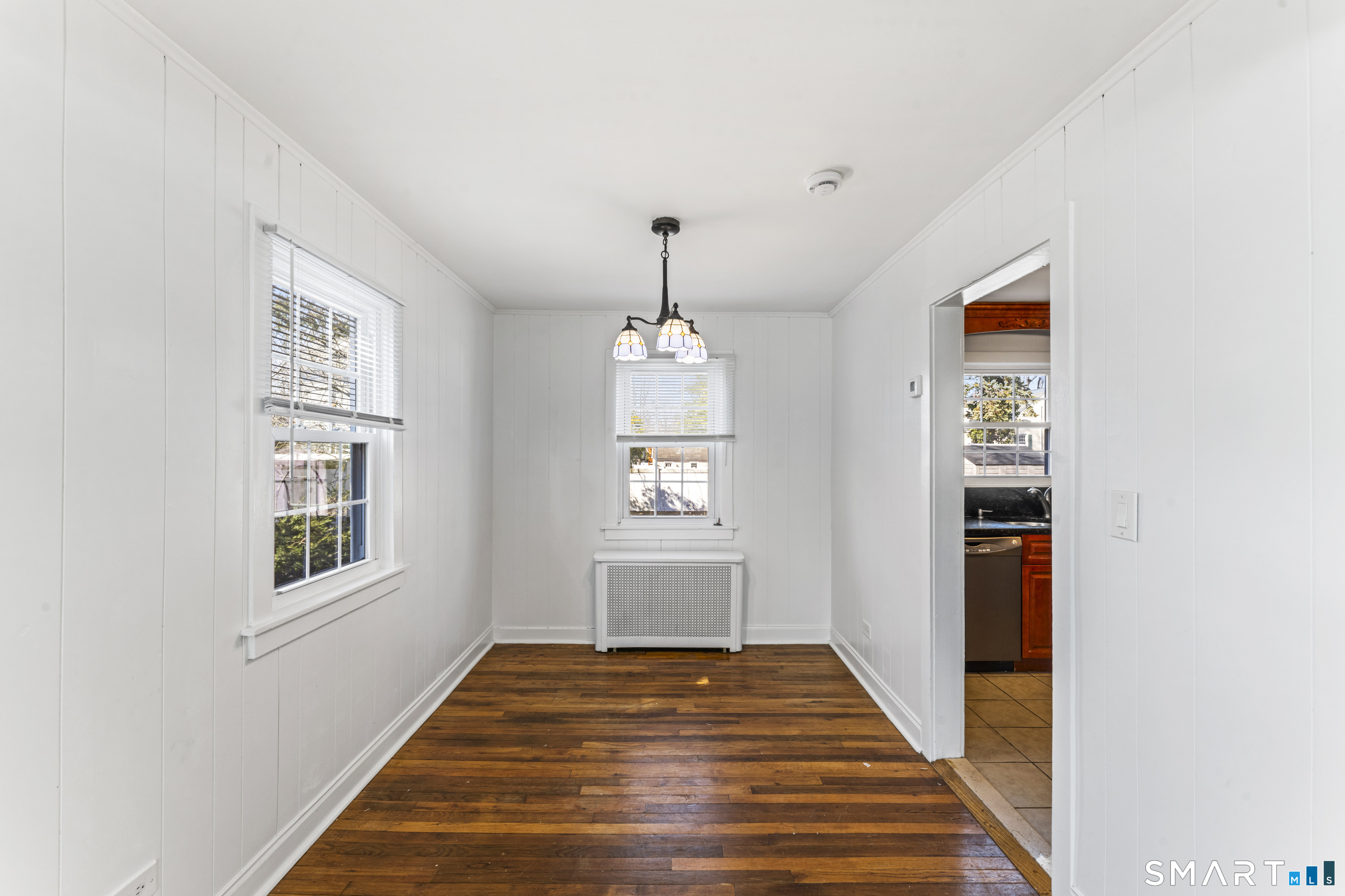 167 Hollow Tree Ridge Road Darien, CT 06820 - Photo 19 of 38 a hallway with wooden floor windows and entryway