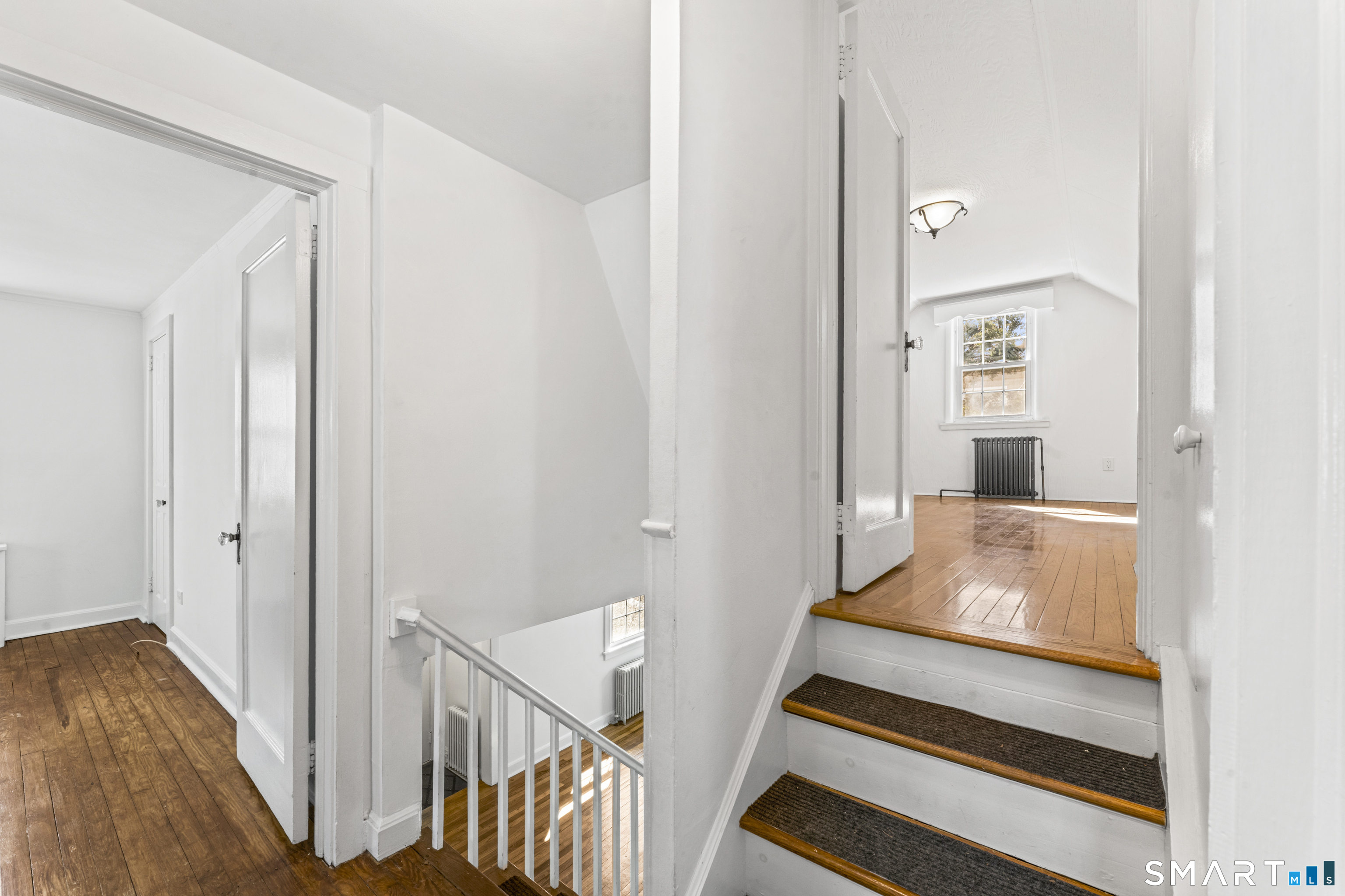 167 Hollow Tree Ridge Road Darien, CT 06820 - Photo 23 of 38 a room with wooden floor and a rug