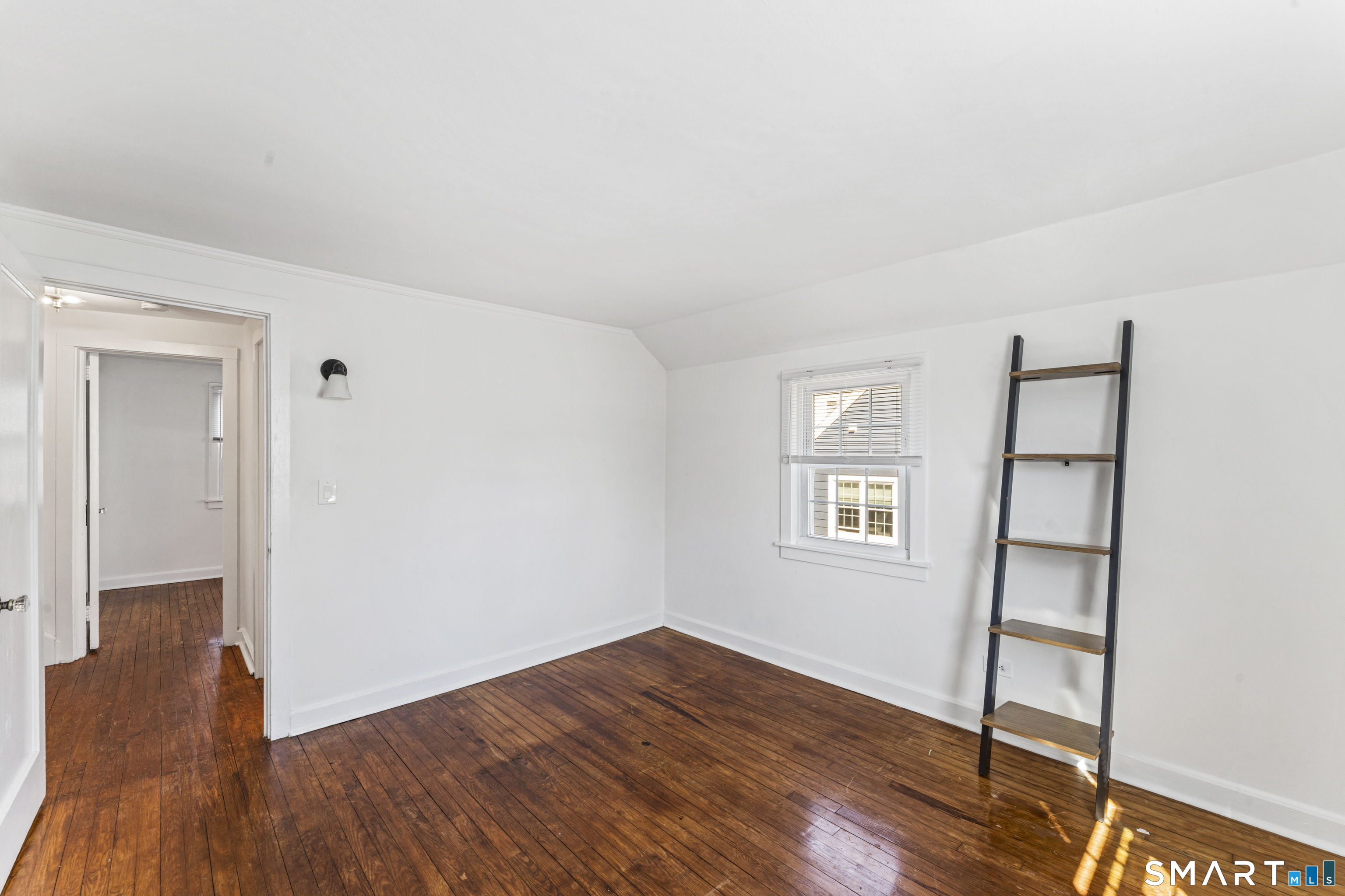 167 Hollow Tree Ridge Road Darien, CT 06820 - Photo 26 of 38 an empty room with wooden floor and windows