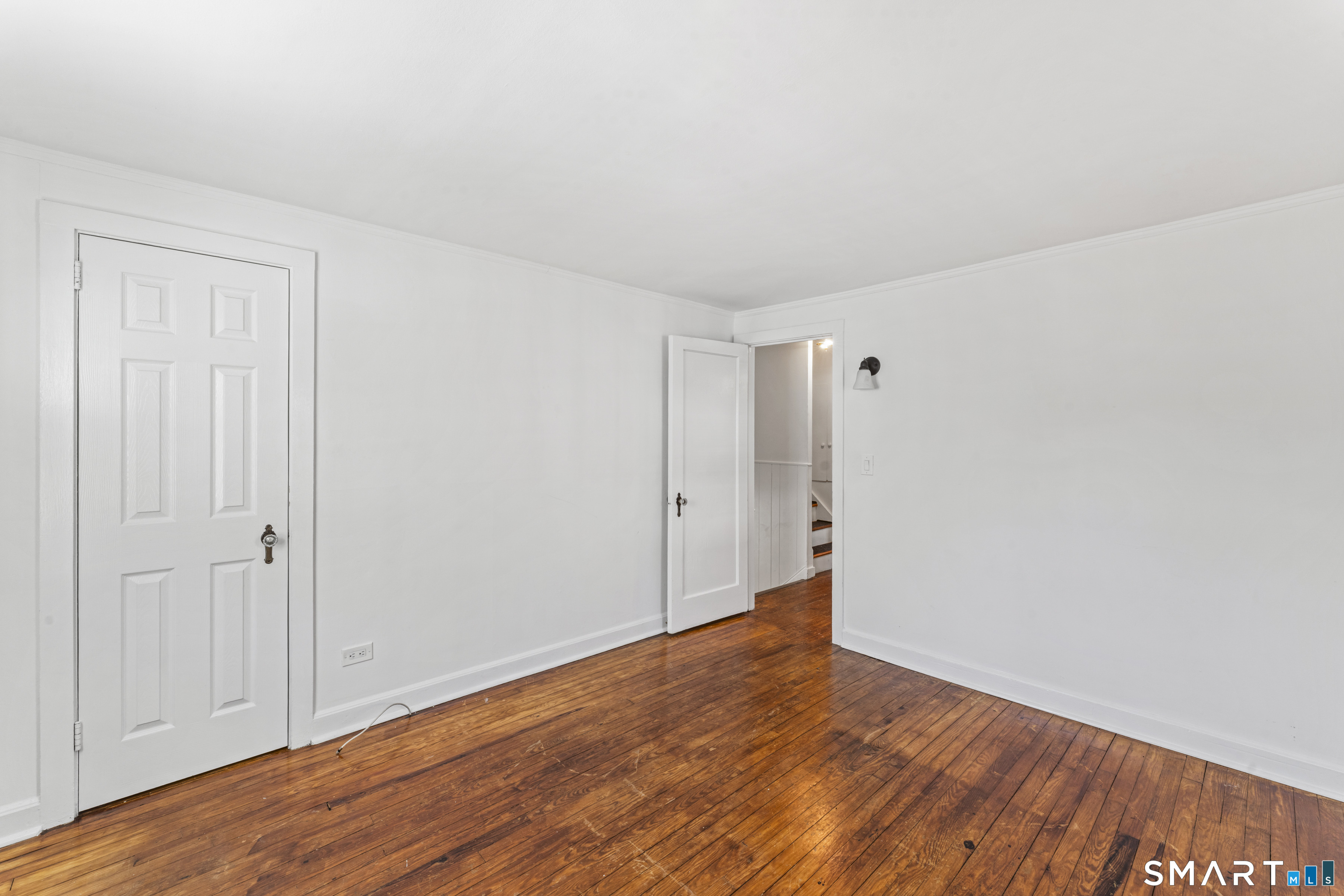 167 Hollow Tree Ridge Road Darien, CT 06820 - Photo 27 of 38 a view of an empty room with wooden floor