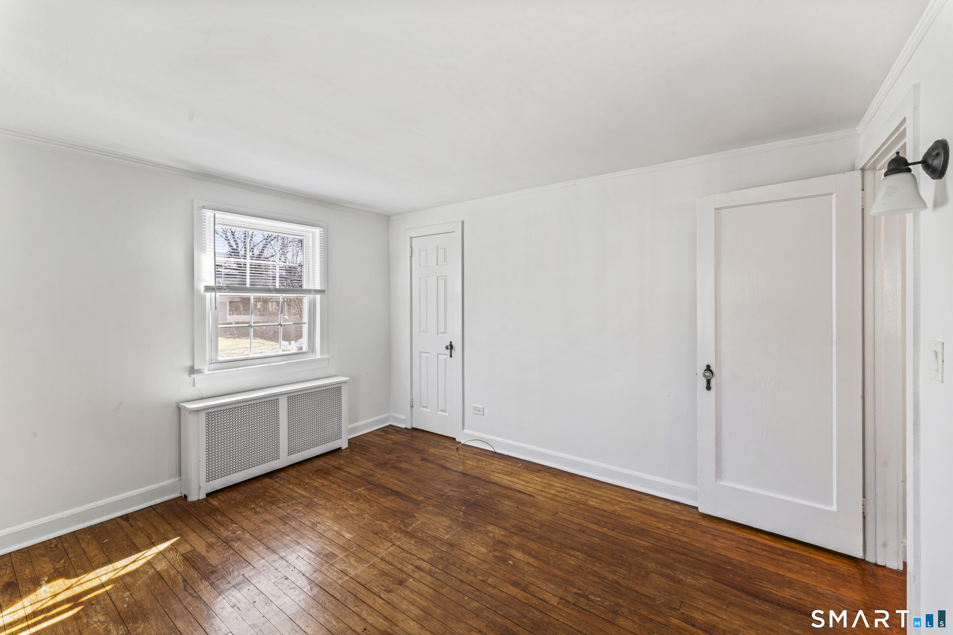 167 Hollow Tree Ridge Road Darien, CT 06820 - Photo 28 of 38 a view of empty room with wooden floor and fan