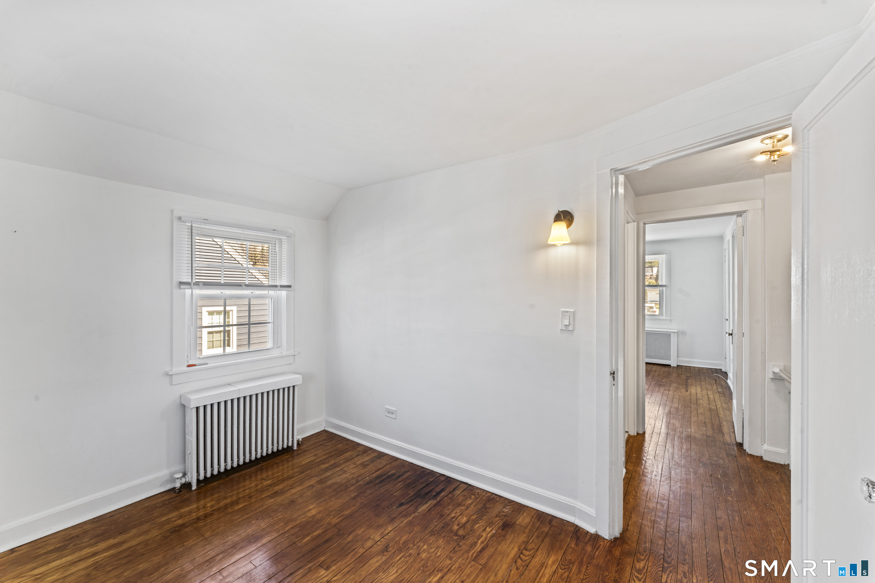 167 Hollow Tree Ridge Road Darien, CT 06820 - Photo 30 of 38 an empty room with wooden floor and windows