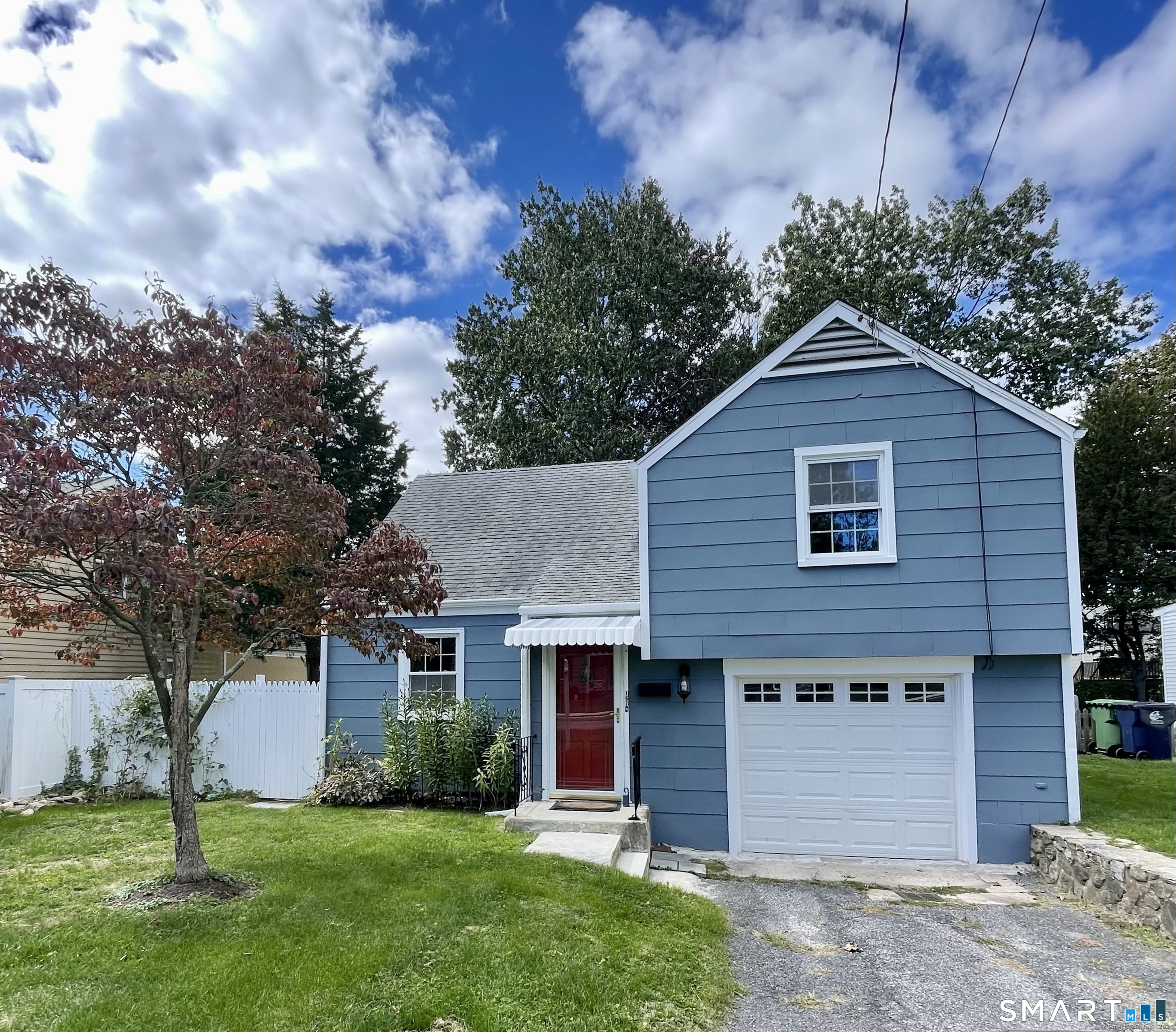 167 Hollow Tree Ridge Road Darien, CT 06820 - Photo 3 of 38 a front view of a house with a garden and yard