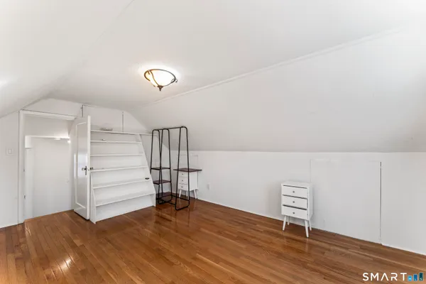 a view of a room with wooden floor