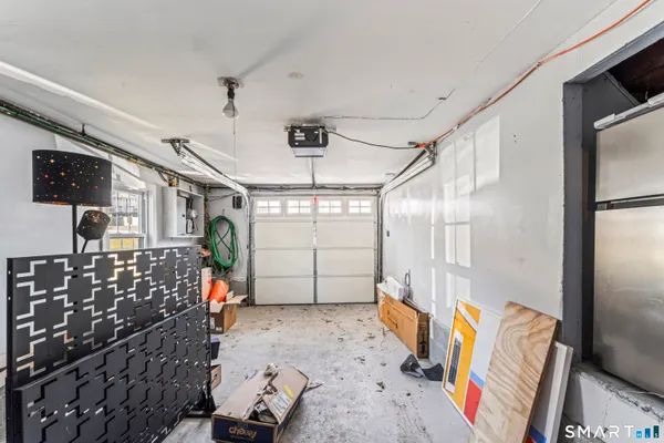 a bedroom with furniture a flat screen tv and a window