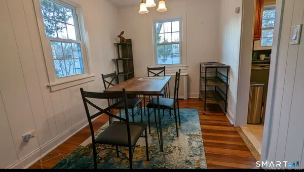 a view of a dining room with furniture and window