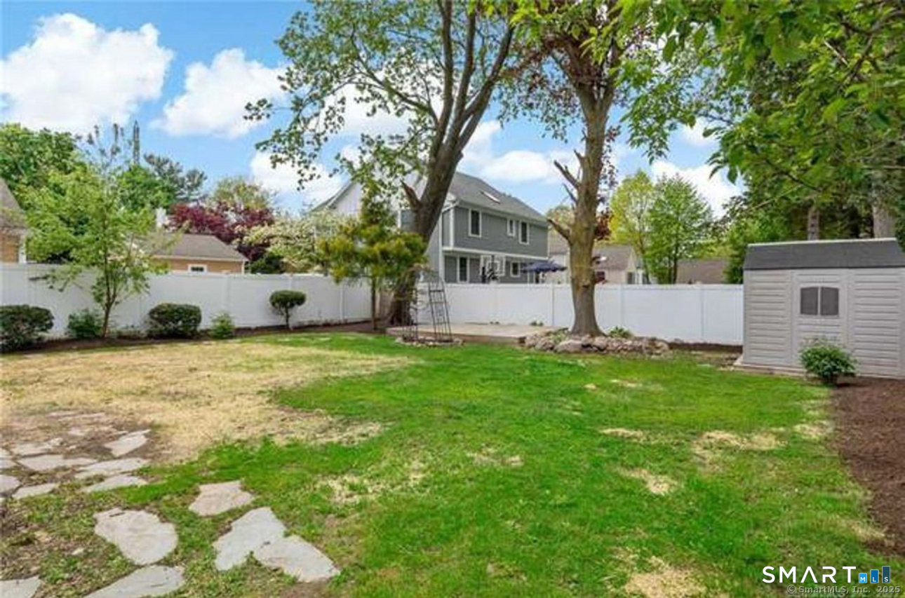 167 Hollow Tree Ridge Road Darien, CT 06820 - Photo 9 of 38 a front view of house with yard and trees