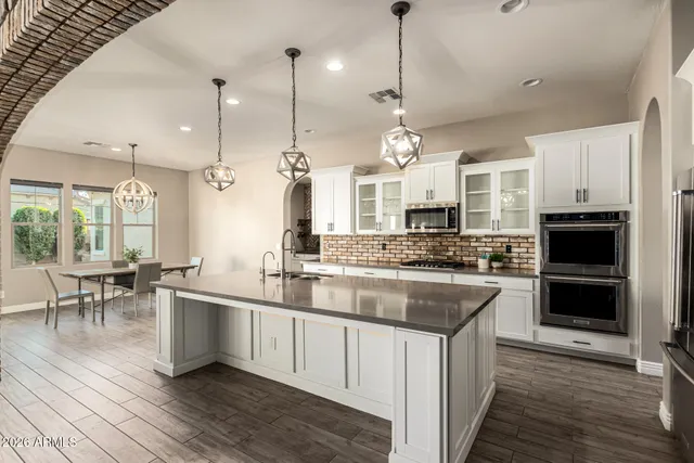 a kitchen with stainless steel appliances kitchen island a large island in the center