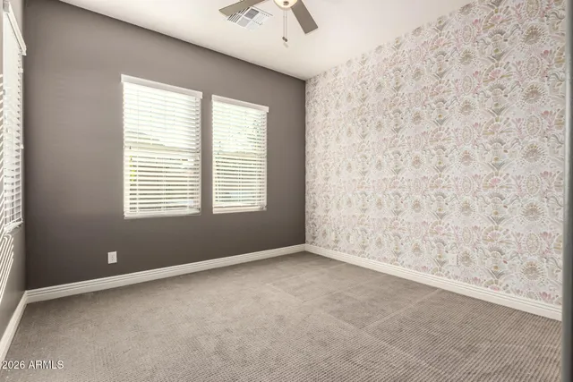 an empty room with windows and closet