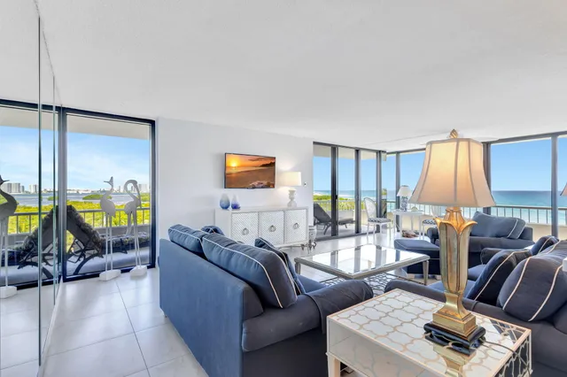a living room with furniture and a dining table with kitchen view
