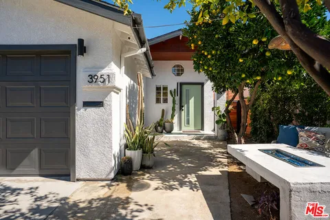 a view of a house with a door and wooden fence