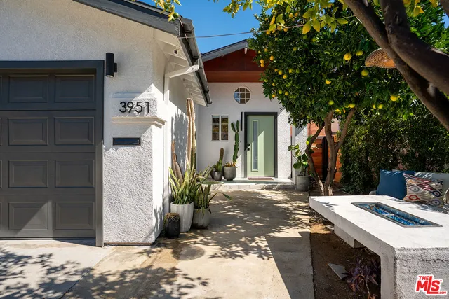 a view of a house with a door and wooden fence