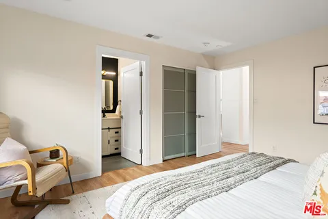 a bedroom with a bed and chair