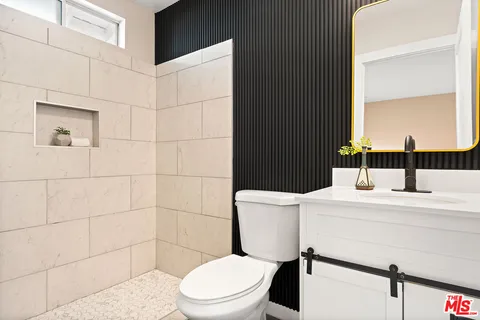 a white toilet sitting next to a bathroom sink