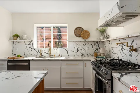 a kitchen with a stove and a sink