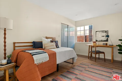 a bedroom with two beds and a table