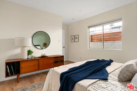 a bedroom with a large bed and a window