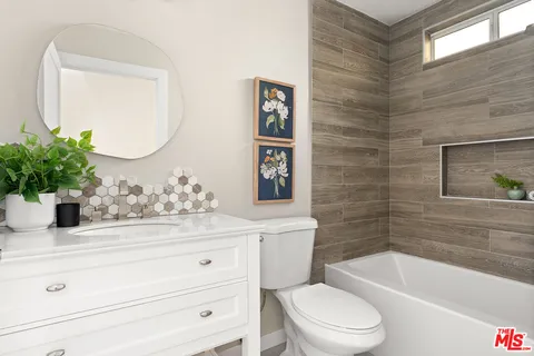 a bathroom with a toilet a sink and bathtub