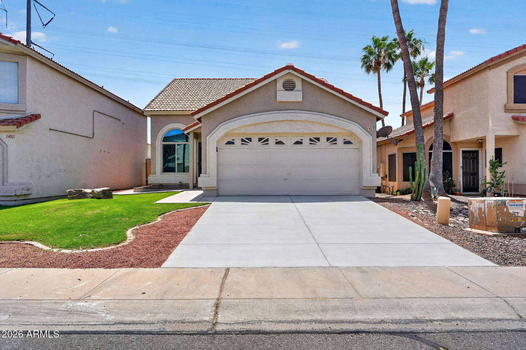 1417 East Mineral Road Gilbert, AZ 85234 - Photo 1 of 59 a front view of a house with a garden
