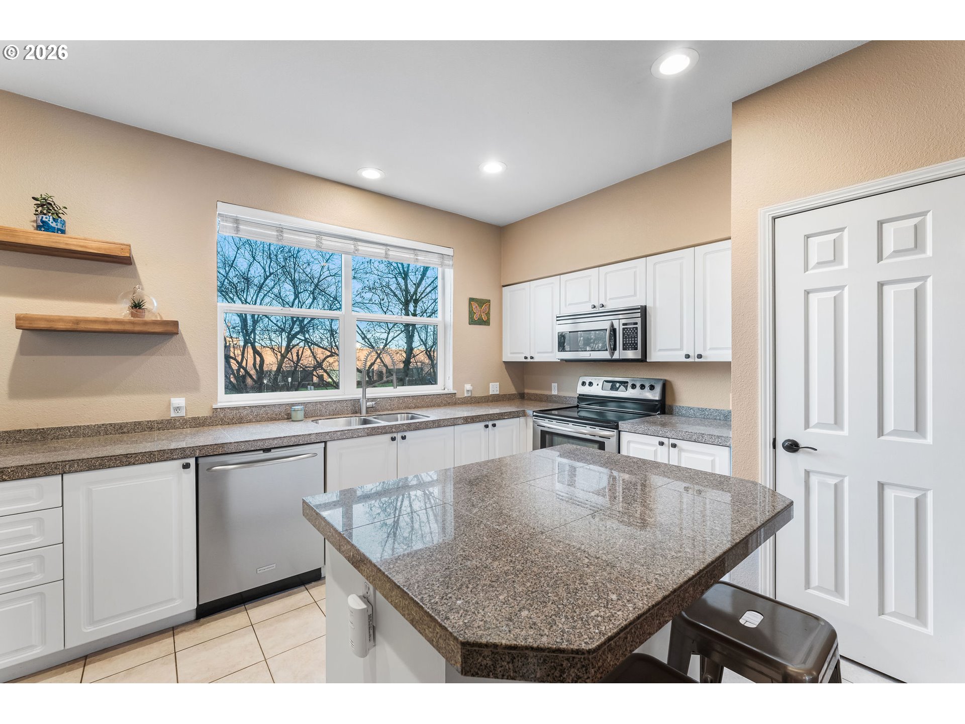 1816 Southeast Cutter Lane Vancouver, WA 98661 - Photo 15 of 43 a kitchen with stainless steel appliances granite countertop a sink counter space and a window