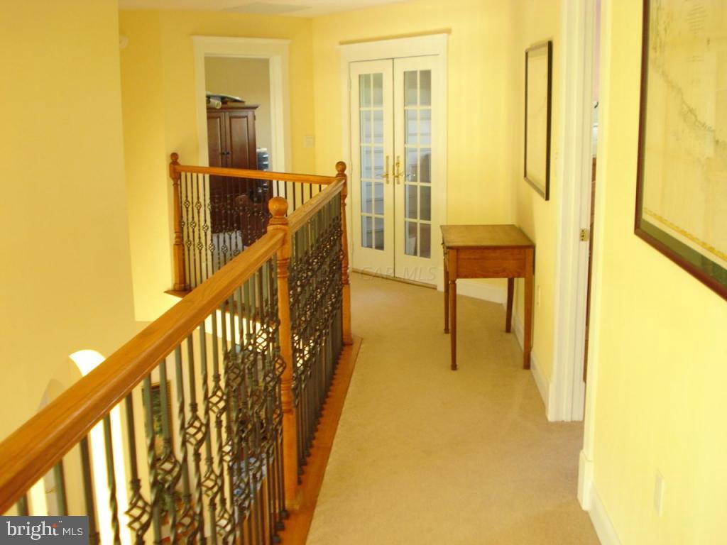 7840 Queponco Road Newark, MD 21841 - Photo 29 of 43 a view of a hallway with wooden floor and furniture