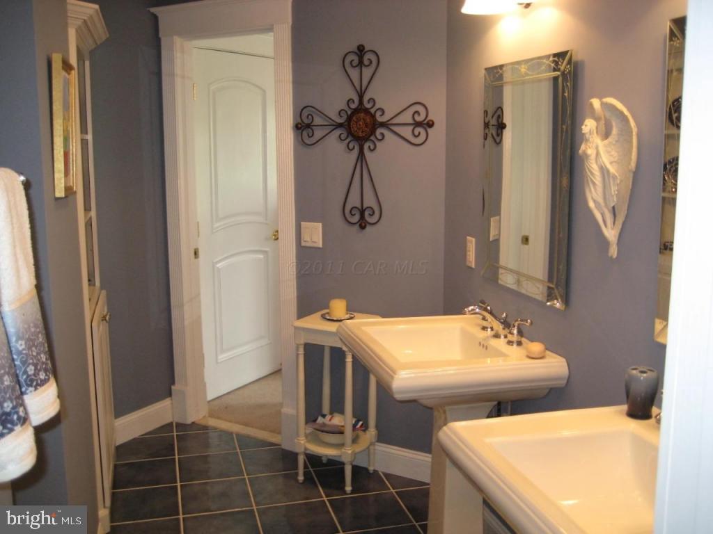 7840 Queponco Road Newark, MD 21841 - Photo 33 of 43 a bathroom with a double vanity sink and mirror