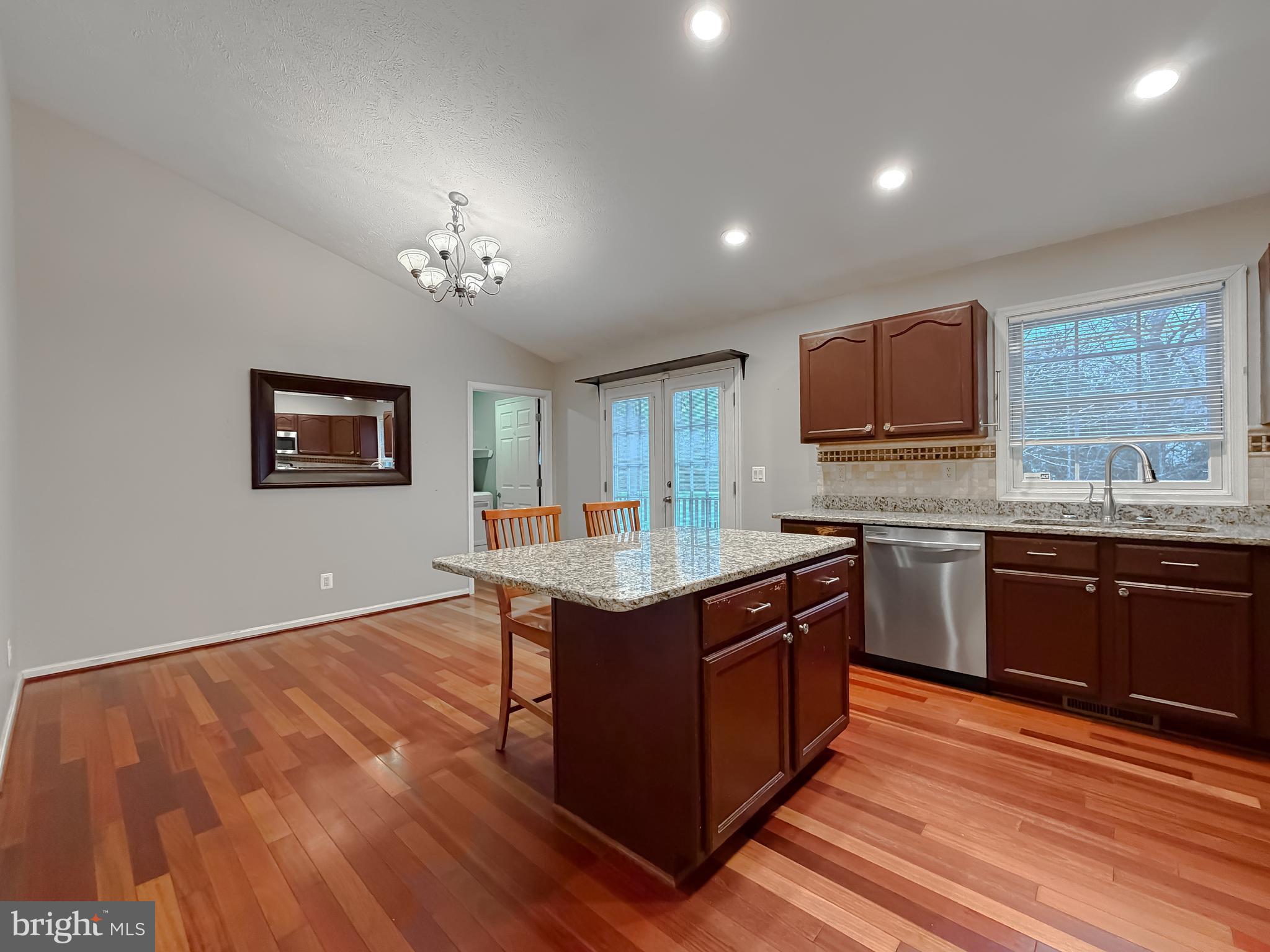 19830 Fall Court Great Mills, MD 20634 - Photo 11 of 47 a kitchen with stainless steel appliances granite countertop a stove a sink dishwasher and a microwave oven with wooden floor