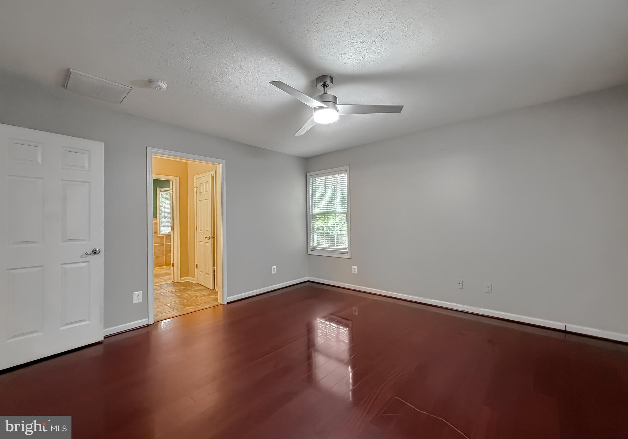 19830 Fall Court Great Mills, MD 20634 - Photo 18 of 47 an empty room with wooden floor and windows