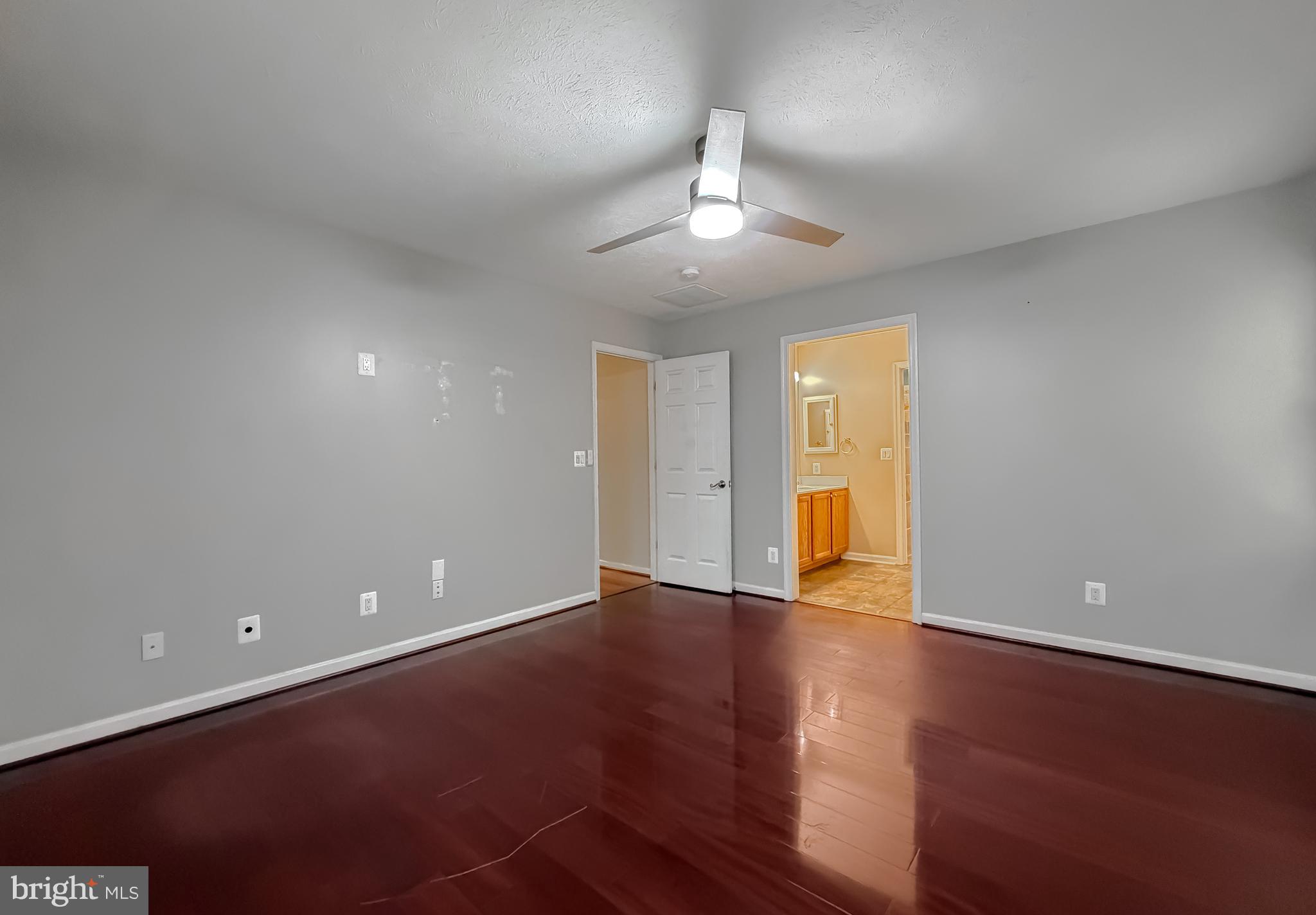 19830 Fall Court Great Mills, MD 20634 - Photo 19 of 47 an empty room with wooden floor and chandelier