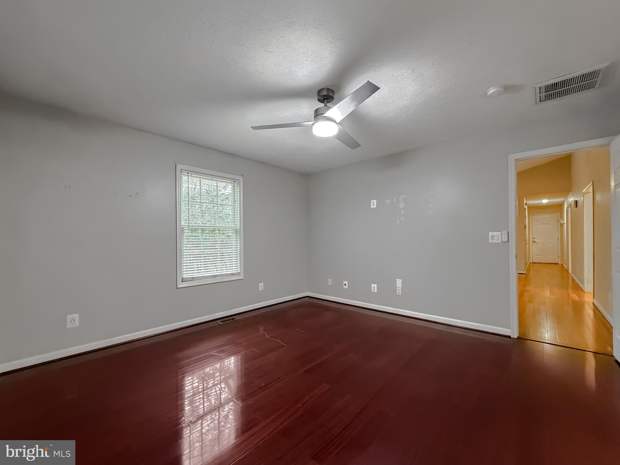 19830 Fall Court Great Mills, MD 20634 - Photo 20 of 47 an empty room with a window and a ceiling fan