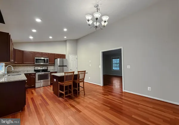 a kitchen with stainless steel appliances a sink and microwave