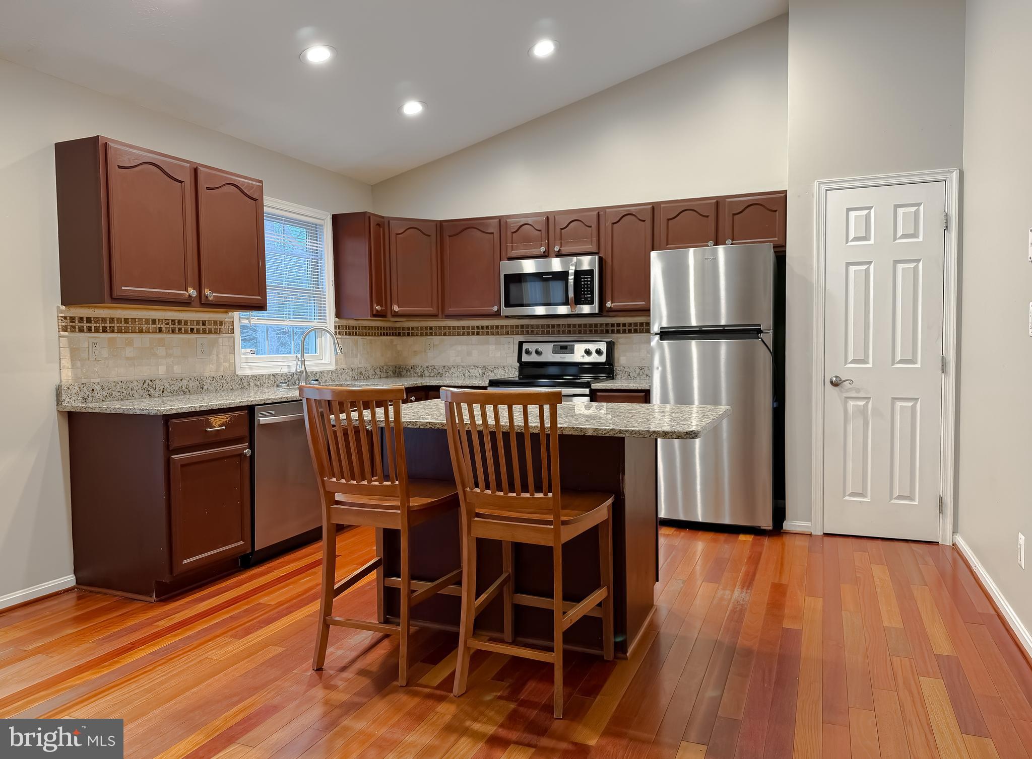 19830 Fall Court Great Mills, MD 20634 - Photo 8 of 47 a kitchen with stainless steel appliances wooden floors and wooden cabinets