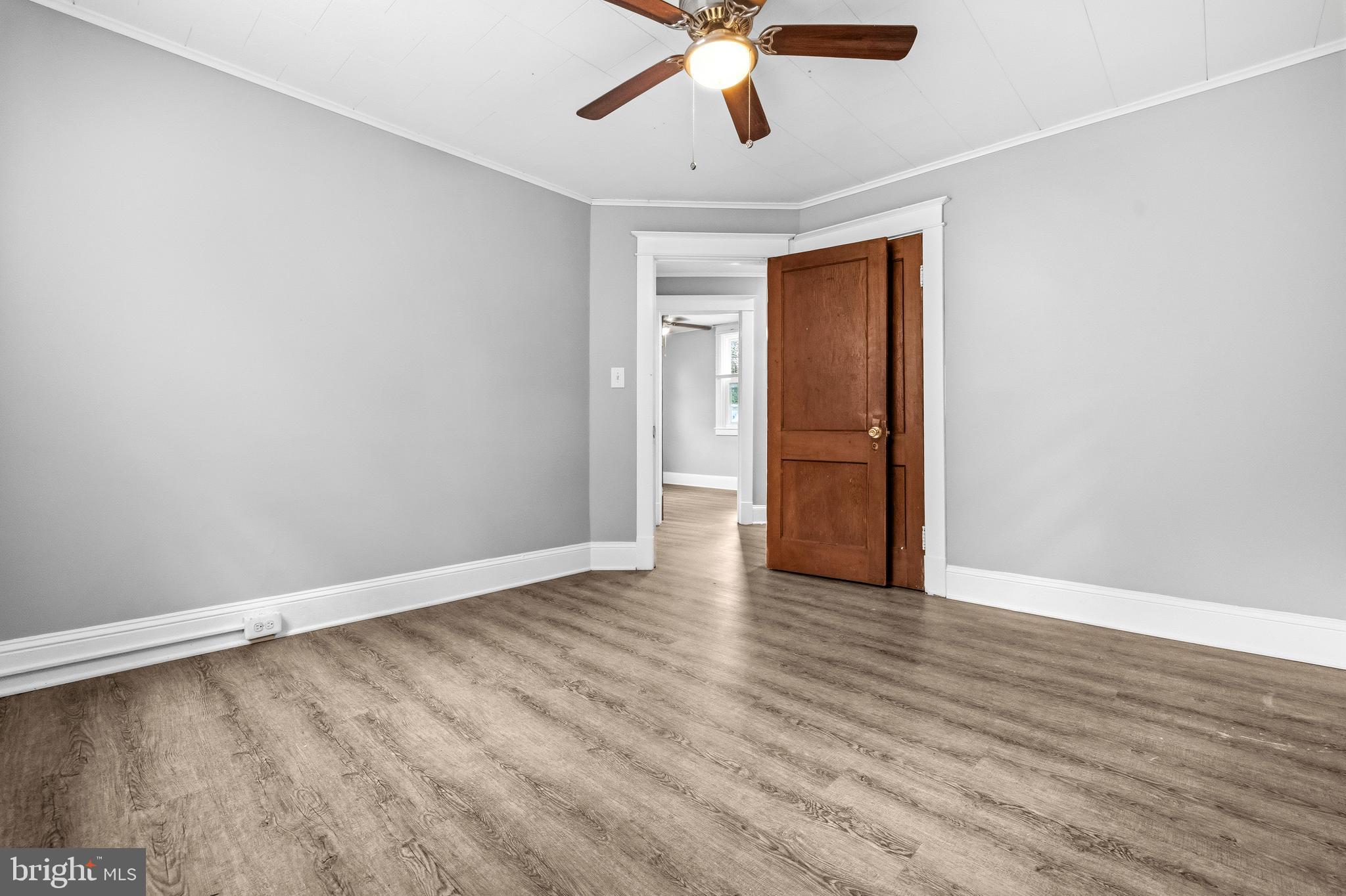 12 Leeway Dundalk, MD 21222 - Photo 23 of 34 an empty room with wooden floor and windows