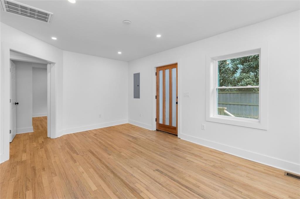 148 Bixby Terrace Southeast Atlanta, GA 30317 - Photo 12 of 19 a view of an empty room with wooden floor and a window