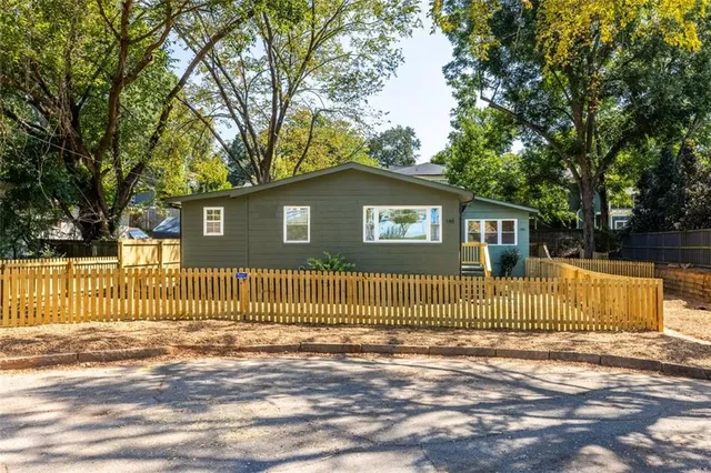 a front view of a house having a garden