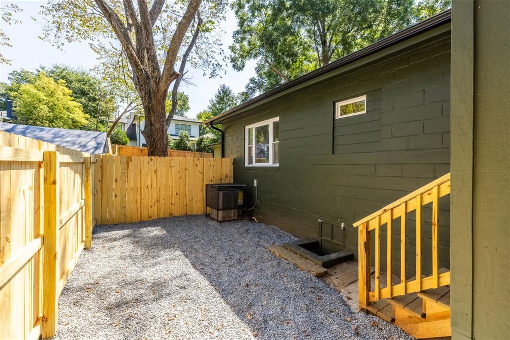 148 Bixby Terrace Southeast Atlanta, GA 30317 - Photo 3 of 19 a view of a backyard with wooden fence and large trees