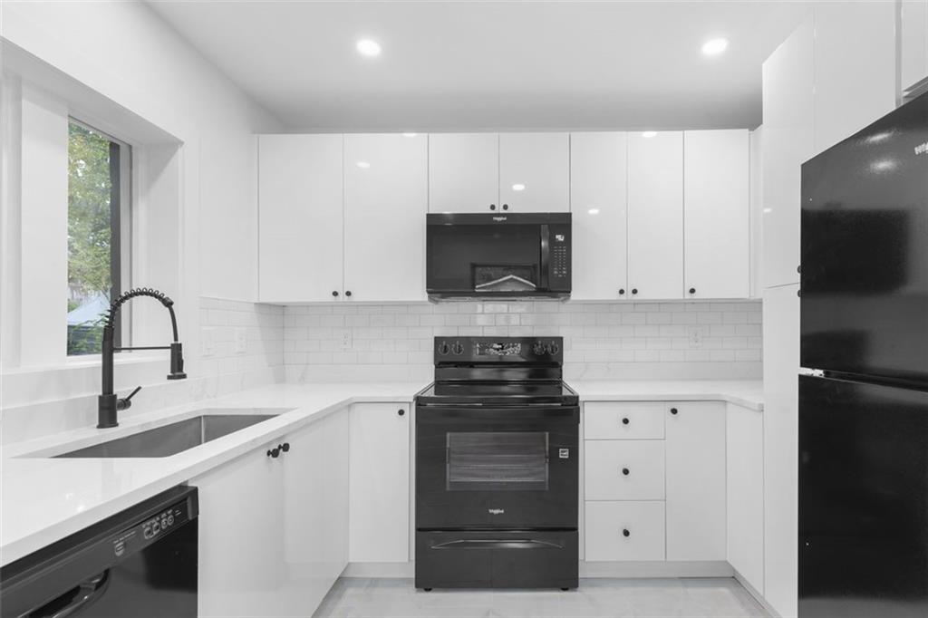 148 Bixby Terrace Southeast Atlanta, GA 30317 - Photo 6 of 19 a kitchen with white cabinets and appliances