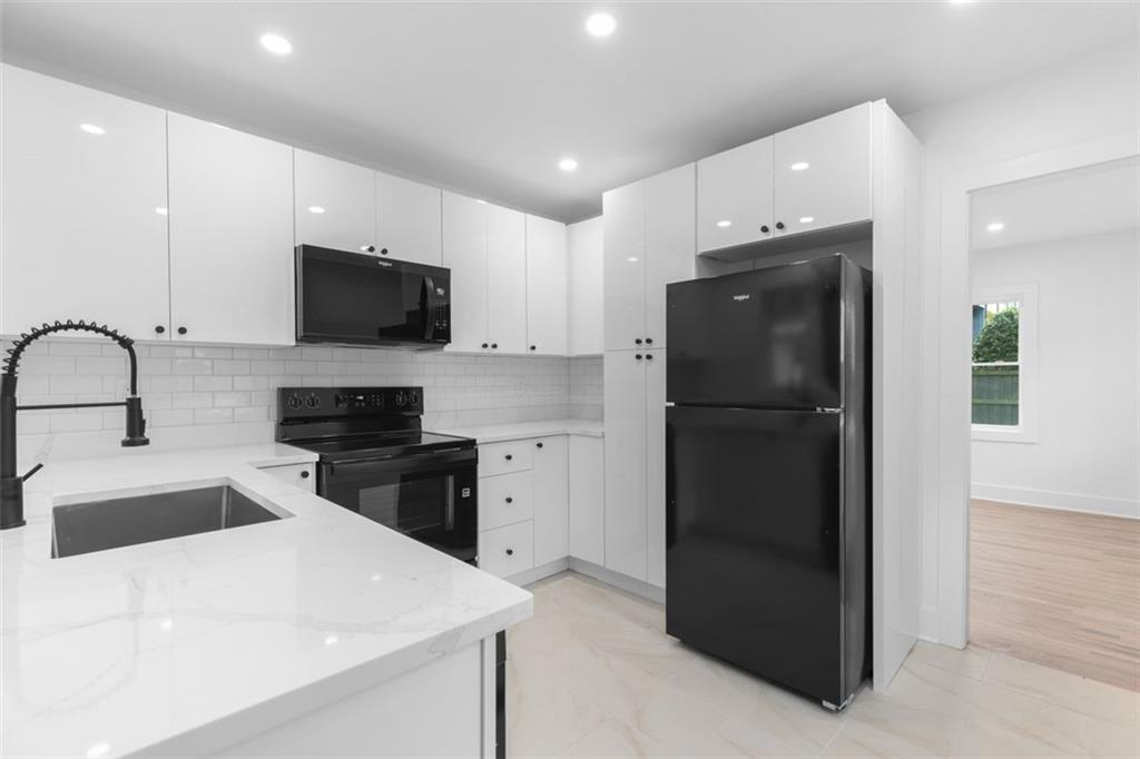 148 Bixby Terrace Southeast Atlanta, GA 30317 - Photo 7 of 19 a kitchen with a refrigerator and a stove top oven