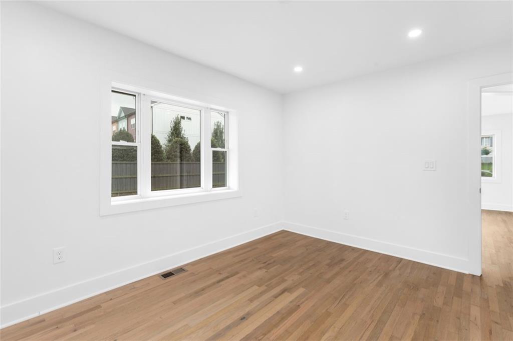 148 Bixby Terrace Southeast Atlanta, GA 30317 - Photo 10 of 19 an empty room with wooden floor and windows
