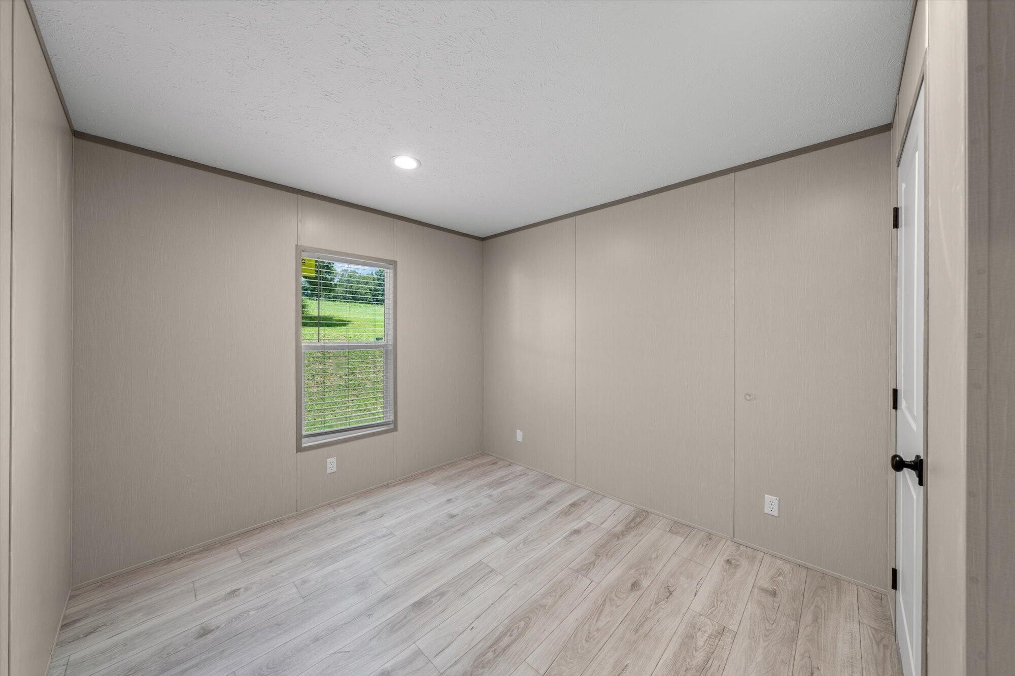 612 Caldwell Road Loudon, TN 37774 - Photo 14 of 16 an empty room with wooden floor and windows